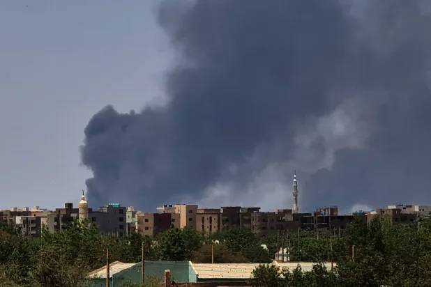 Smoke billows over buildings in Khartoum on May 1, 2023 as deadly clashes between rival generals' forces have entered their third week.(Photo by AFP)