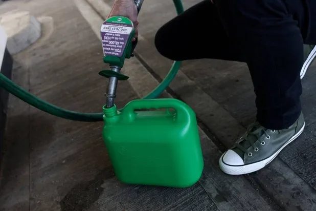  A motorist fills a container with fuel at a petrol station, as the price of oil and gas has surged amid the conflict in the Middle East, in London, Britain, March 5, 2026 (Reuters)