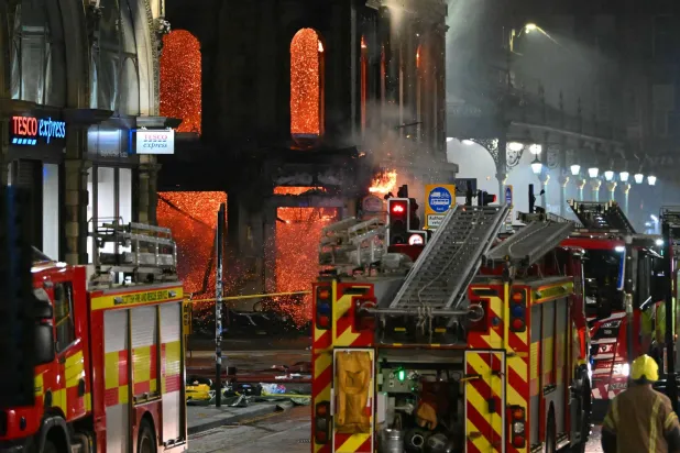  Floors collapse inside the building as fire fighters work at the site of a large fire in Glasgow City center on March 8, 2026. (AFP) 