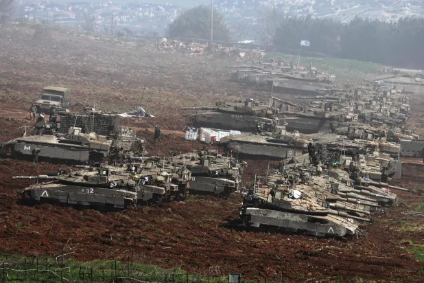  Israeli tanks gather at a position along the Israel-Lebanon border on March 8, 2026. (Photo by Jack GUEZ / AFP)