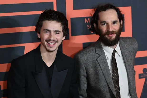 French-American actor Timothee Chalamet (L) and American film director Josh Safdie pose upon arrival on the red carpet for screening of their film “Marty Supreme” in Beijing on March 10, 2026. (AFP) 