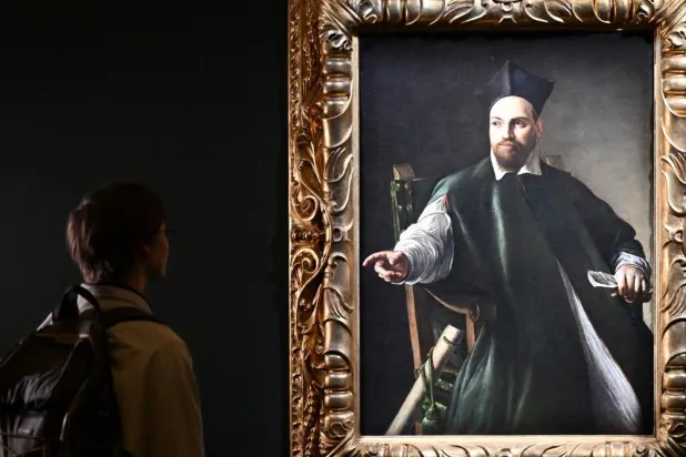 A visitor looks at the private collection and never previously shown to the public painting "Portrait de Maffeo Barberini" by Italian master Caravaggio at the Gallerie Nazionali di Arte Antica in the Barberini palace in Rome on November 22, 2024. (Alberto Pizzoli / AFP) 