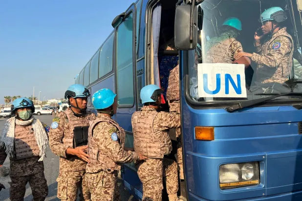Members of the UNIFIL peacekeeping force enter a bus at the site of an Israeli strike at the northern entrance of the southern city of Sidon, on November 7, 2024, amid the ongoing war between Israel and Hezbollah.  (Photo by Mahmoud ZAYAT / AFP)