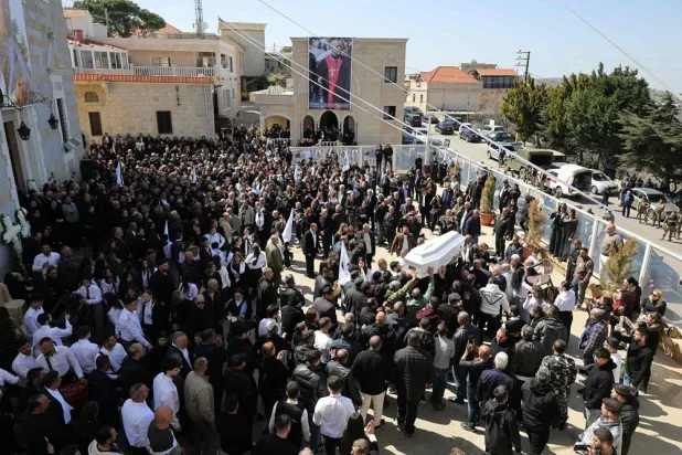 Residents of the Christian Lebanese border village of Qlayaa carry the coffin of the village's priest, Father Pierre al-Rai during his funeral on March 11, 2026. (AFP)