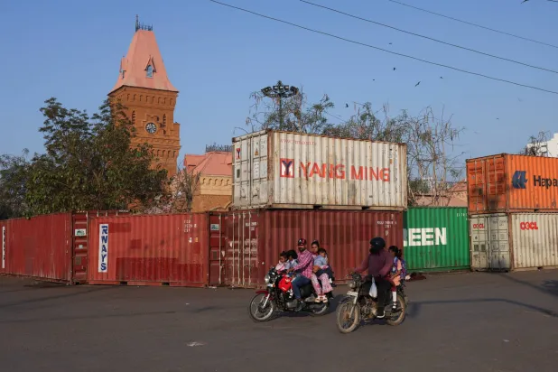 Students ride on motorbikes with their parents while heading to schools, after the government announced that schools would close for two weeks, starting March 16, following austerity measures to save fuel amid the US-Israeli conflict with Iran, in Karachi, Pakistan, March 10, 2026. REUTERS/Akhtar Soomro
