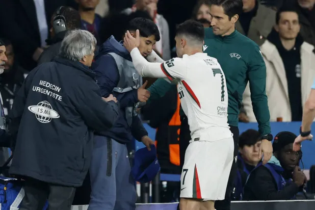 Soccer Football - UEFA Champions League - Round of 16 - First Leg - Paris St Germain v Chelsea - Parc des Princes, Paris, France - March 11, 2026 Chelsea's Pedro Neto checks on ball boy after falling into him Action Images via Reuters/Peter Cziborra