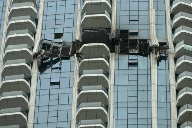 Workers inspect the damage at the Address Creek Harbour hotel in Dubai, United Arab Emirates, Thursday, March 12, 2026. (AP Photo/Fatima Shbair)