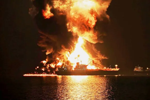 An oil tanker burns after being hit by an Iranian strike in the ship-to-ship transfer zone at Khor al-Zubair port near Basra, Iraq, late Wednesday, March 11, 2026. (AP Photo)