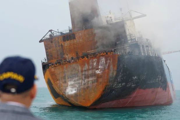 A foreign tanker carrying Iraqi fuel oil damaged after catching fire in Iraq's territorial waters, following unidentified attacks that targeted two foreign tankers, according to Iraqi port officials, near Basra, Iraq, March 12, 2026.  REUTERS/Mohammed Aty