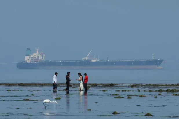Tourists watch marine life, with the MT Desert Kite oil tanker carrying Russian oil in the background, at Narara Marine National Park in the Arabian Sea, Gujarat, India March 11 , 2026. (Reuters)