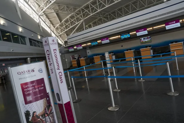 An empty check-in counter for Qatar Airways, amid the US-Israel conflict with Iran, at Terminal 8 at John F. Kennedy (JFK) International Airport in New York City, US, March 2, 2026.  REUTERS/Bing Guan