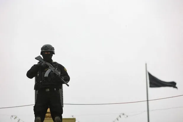 A security personnel stands guard as Iranians take part in a protest marking the annual al-Quds Day (Jerusalem Day) on the last Friday of the holy month of Ramadan, amid the US-Israeli conflict with Iran, in Tehran, Iran, March 13, 2026. Majid Asgaripour/WANA (West Asia News Agency) via Reuters