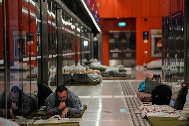 Israelis take shelter in a subway station as sirens warn of incoming Iranian missiles over Tel Aviv on March 7 (AP)