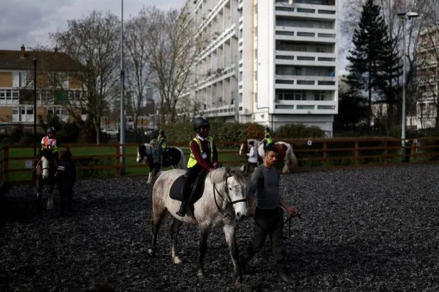Children ride horses around a paddock during a class at the Ebony Horse Club in Brixton, Britain's most urban riding school, where children from under-privileged communities are taught to ride horses, in London, Britain, March 10, 2026. (Reuters)