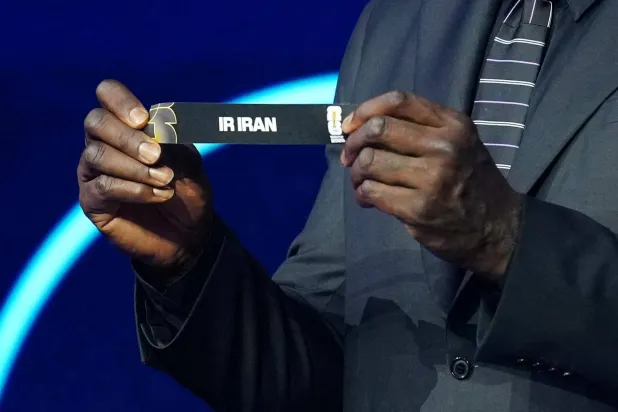 Football - FIFA World Cup 2026 - FIFA World Cup 2026 Draw - John F. Kennedy Center for the Performing Arts, Washington, DC, US - December 5, 2025 Draw Assistant Shaquille O'Neal draws out Iran during the FIFA World Cup 2026. (Draw Pool via Reuters)