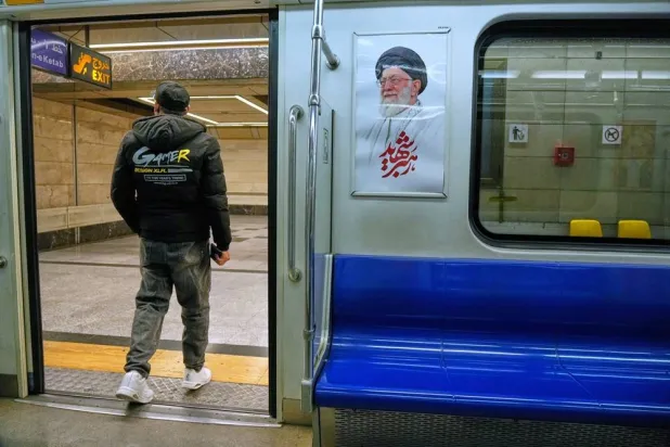  A man leaves a subway train past an image of the late Iranian Supreme Leader Ali Khamenei, in Tehran, Iran, Friday, March 13, 2026. (AP)