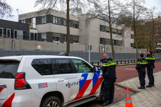 Police officers stand outside a Jewish school following an explosion that caused minor damages, in Amsterdam, Netherlands, March 14, 2026. REUTERS/Piroschka van de Wouw