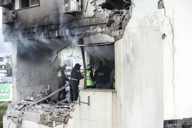 Firefighters and first aid responders work inside an apartment that was targeted by an Israeli airstrike in the Burj Hammoud area on the northern outskirts of Beirut on March 14, 2026. (Photo by IBRAHIM AMRO / AFP)