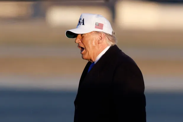 President Donald Trump prepares to board Air Force One after speaking to reporters at Joint Base Andrews, Md., Friday, March 13, 2026. (AP Photo/Luis M. Alvarez)