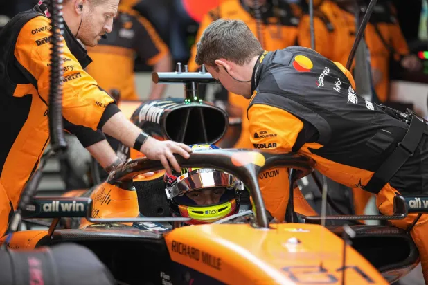 Mechanics work on the car of McLaren's Australian driver Oscar Piastri during the Formula One Chinese Grand Prix at the Shanghai International Circuit in Shanghai on March 15, 2026. (AFP)
