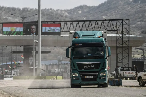 A truck drives at the Iraq-Iran border crossing of Bashmagh near Sulaimaniyah in Iraq's autonomous Kurdistan region on March 11, 2026. (AFP)