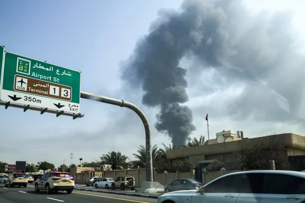 A smoke plume rises from a fire at Dubai International Airport in Dubai on March 16, 2026. (Photo by AFP) 