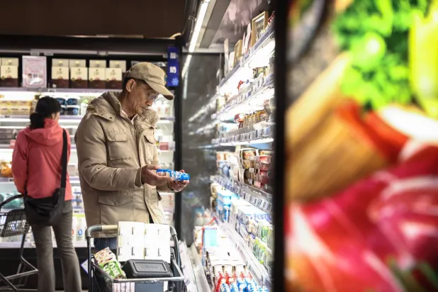 متسوقون في أحد المتاجر الغذائية الكبرى بالعاصمة الصينية بكين (إ.ب.أ)