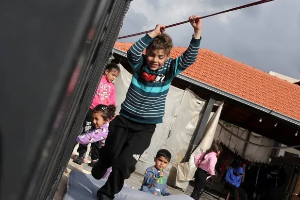 A child plays during a visit by Lebanon’s Health Minister Rakan Nassereddine to Maroun Abboud Secondary Public School, which is hosting displaced people, following an escalation between Hezbollah and Israel amid the US-Israeli conflict with Iran, in Aley district, Mount Lebanon Governorate, Lebanon, March 15, 2026. (Reuters)