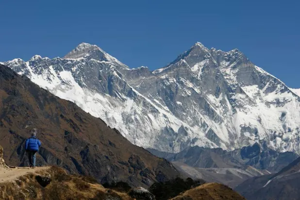 A tourist looks at a view of Mt. Everest from the hills of Syangboche in Nepal December 3, 2009. REUTERS/Gopal Chitrakar 