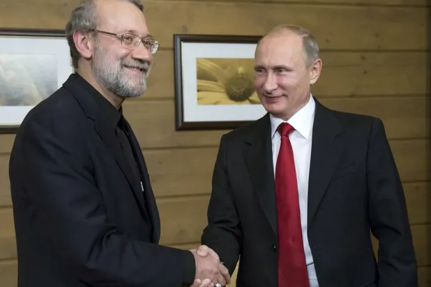 Russia's President Vladimir Putin (R) shakes hands with Iran's then parliament Speaker Ali Larijani as they meet after a session of the Valdai International Discussion Club in Sochi, Russia, October 22, 2015. (Reuters)