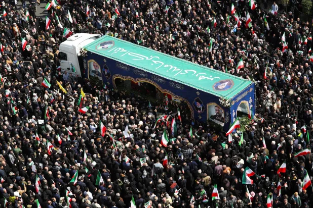  People gather around the coffin of Iranian security chief Ali Larijani during a funeral for Larijani and victims of the IRIS Dena warship at Enghelab Square, amid the US-Israeli conflict with Iran, in Tehran, Iran, March 18, 2026. (Reuters)