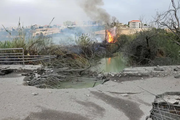 This photograph shows the destroyed Qasmiye Bridge built over the Litani River, following an Israeli airstrike, in Qasmiye on March 18, 2026. (AFP)