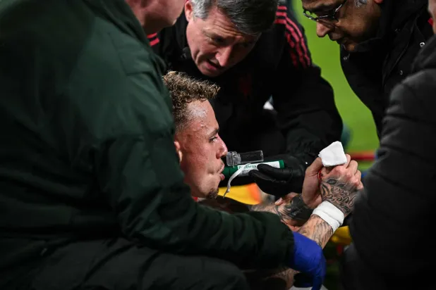 Galatasaray's Dutch forward #77 Noa Lang receives medical attention after cutting his thumb during the UEFA Champions League, round of 16 second leg football match between Liverpool and Galatasaray at Anfield in Liverpool, north-west England on March 18, 2026. (Photo by Paul ELLIS / AFP)