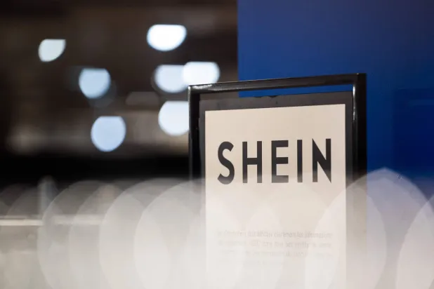 (FILES) This photograph shows the logo of Asian e-commerce giant Shein in its stall at the Bazar de l'Hotel de Ville (BHV) department store in Paris on November 4, 2025. (Photo by Julie SEBADELHA / AFP)