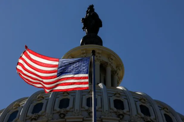 An American Flag on the US Capitol Building is seen in Washington, US, August 31, 2023. REUTERS/Kevin Wurm/File Photo 
