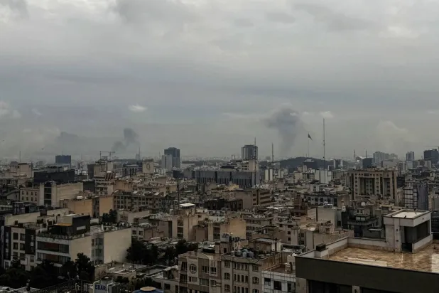 Plumes of smoke rise from the site of a strike in Tehran on March 16, 2026. (AFP)
