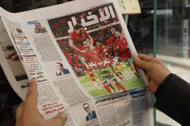 A man holds a Moroccan newspapers following CAF’s decision to strip Senegal of its Africa Cup of Nations (AFCON) title in Rabat on March 18, 2026. (AFP)