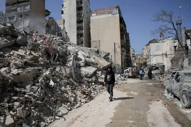 A man walks amid the rubble of buildings destroyed by Israeli bombardment in Beirut’s Zokak el-Blat district near the city center (Reuters)
