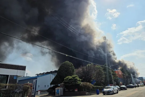 Smoke rises from at a car parts factory in Daejeon, South Korea, March 20, 2026. Yonhap via REUTERS