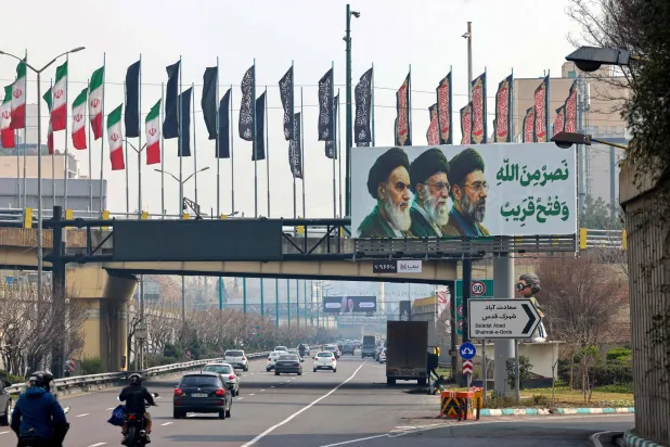 Motorists drive along a street in Tehran on March 14, 2026. (Photo by ATTA KENARE / AFP) 