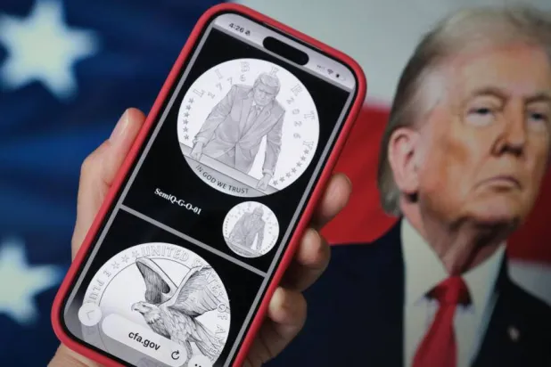 A phone displaying the commemorative gold coin featuring Trump to mark America's 250th anniversary. Chris DELMAS / AFP
