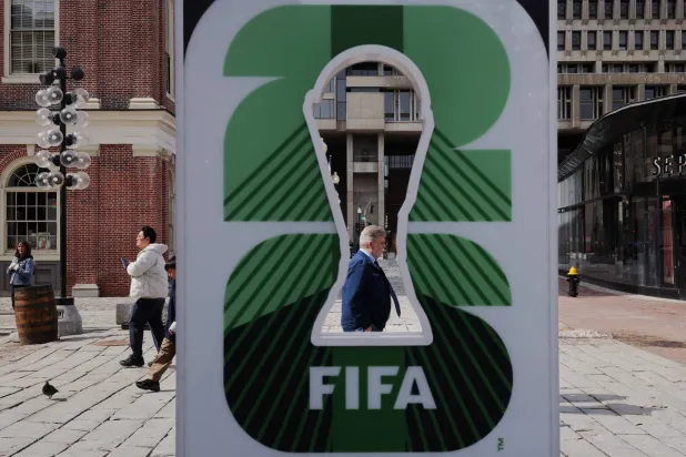 Pedestrians pass the FIFA World Cup 2026 countdown clock in Boston, Massachusetts, US, March 18, 2026. REUTERS/Brian Snyder