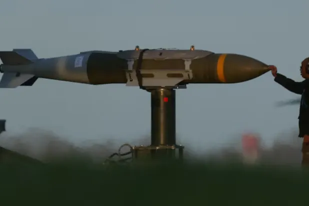A member of ground crew moves munitions towards a USAF B1 B bomber at RAF Fairford airbase, used by USAF personnel, amid the US–Israeli conflict with Iran, in Fairford, Gloucestershire, Britain, March 11, 2026. REUTERS/Phil Noble