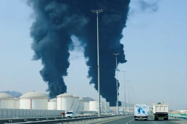Smoke rises in the Fujairah oil industry zone, caused by debris after interception of a drone by air defenses, according to the Fujairah media office, amid the US-Israel conflict with Iran, in Fujairah, United Arab Emirates, March 14, 2026. REUTERS/Staff