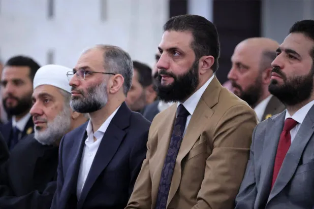 This handout photograph released by the official Syrian Arab News Agency (SANA) shows Syria's interim President Ahmed al-Sharaa (2nd-R) attending the early morning prayers for Eid al-Fitr, marking the end of the holy month of Ramadan, in Damascus on March 20, 2026. (SANA/AFP)
