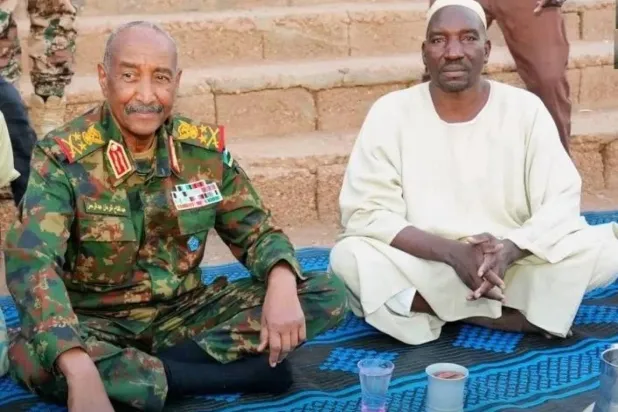 Sudanese army chief Abdel Fattah al-Burhan attends a group iftar with members of the community police in the final days of Ramadan. (Sudanese Armed Forces – Facebook). 
