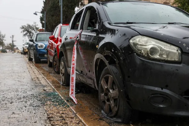 A damaged vehicle is seen in a residential area after impact amid escalation between Hezbollah and Israel, in northern Israel, March 21, 2026. REUTERS/Tyrone Siu