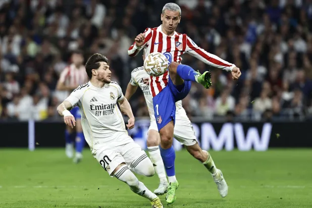  Soccer Football - La Liga - Real Madrid v Atletico Madrid - Santiago Bernabeu, Madrid, Spain - March 22, 2026 Atletico Madrid's Antoine Griezmann in action with Real Madrid's Fran Garcia. (Reuters)