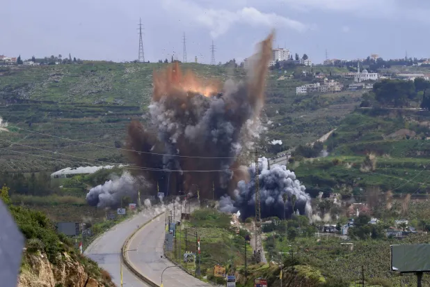 Smoke and flames rise after an Israeli strike targeting the Qasmiyeh bridge near Tyre, in southern Lebanon, 22 March 2026. (EPA)
