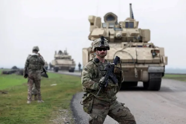 A soldier from the US-led coalition stands guard during a joint US- Kurdish-led Syrian Democratic Forces (SDF) patrol in the countryside of Qamishli in northeastern Syria February 8, 2024. (Reuters) 